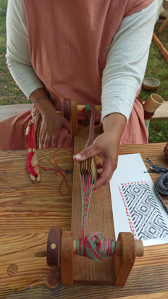 Démonstration de tissage sur un métier à tisser de style médiéval